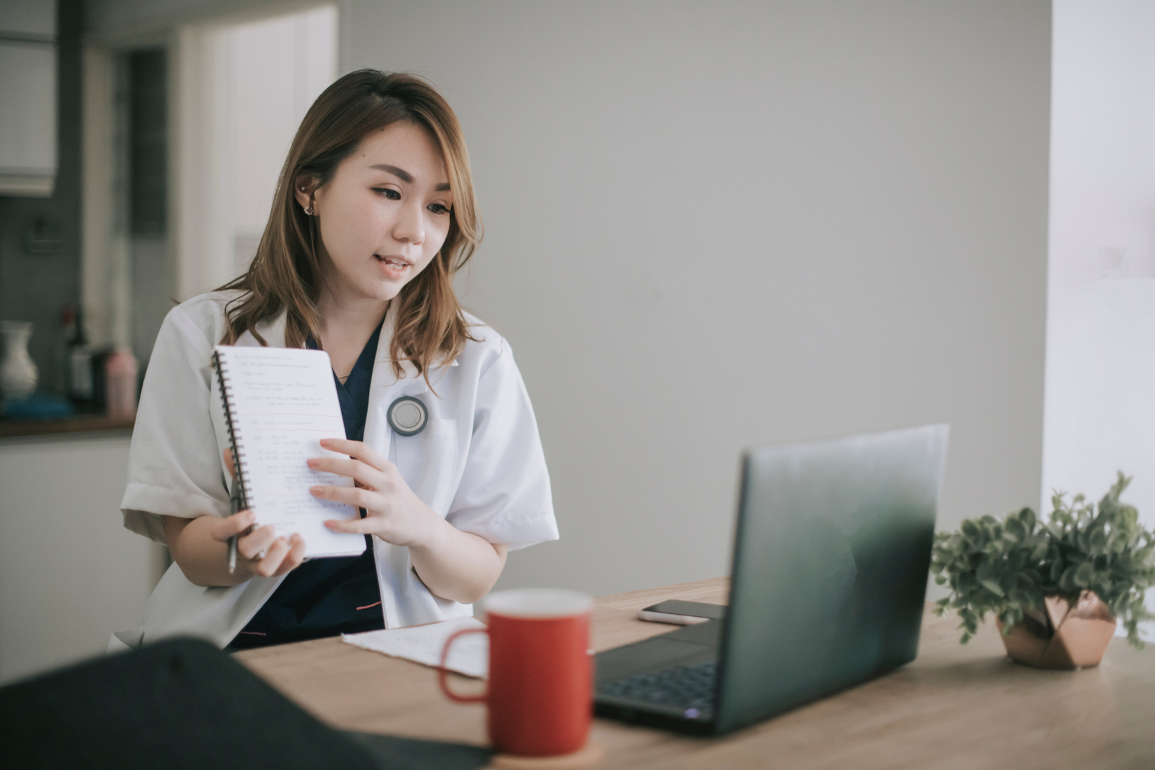 telemedicine telehealth asian chinese female doctor video conference with her patient at home