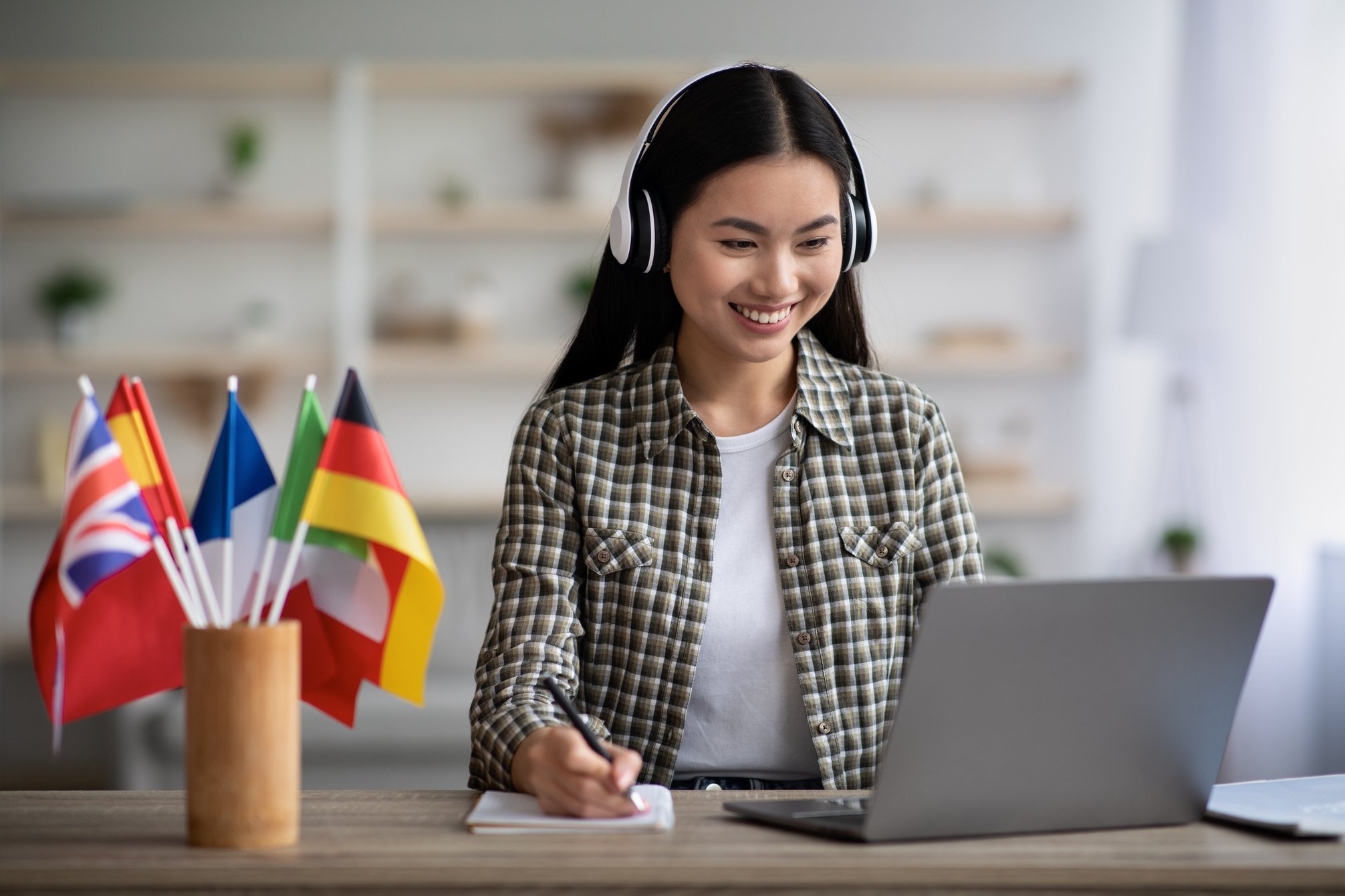 Happy asian woman learning foreign language online